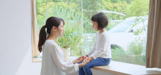 Parent and toddler sitting down talking