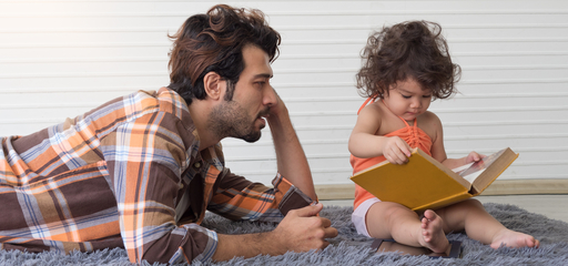 Father and a child reading a book together