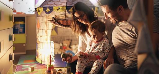 Parents and a baby sitting playing with cubes