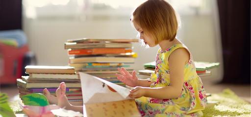 Toddler reading a preschool book